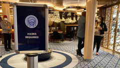 "Masks required" signs are stationed around Holland America Line’s Rotterdam.
